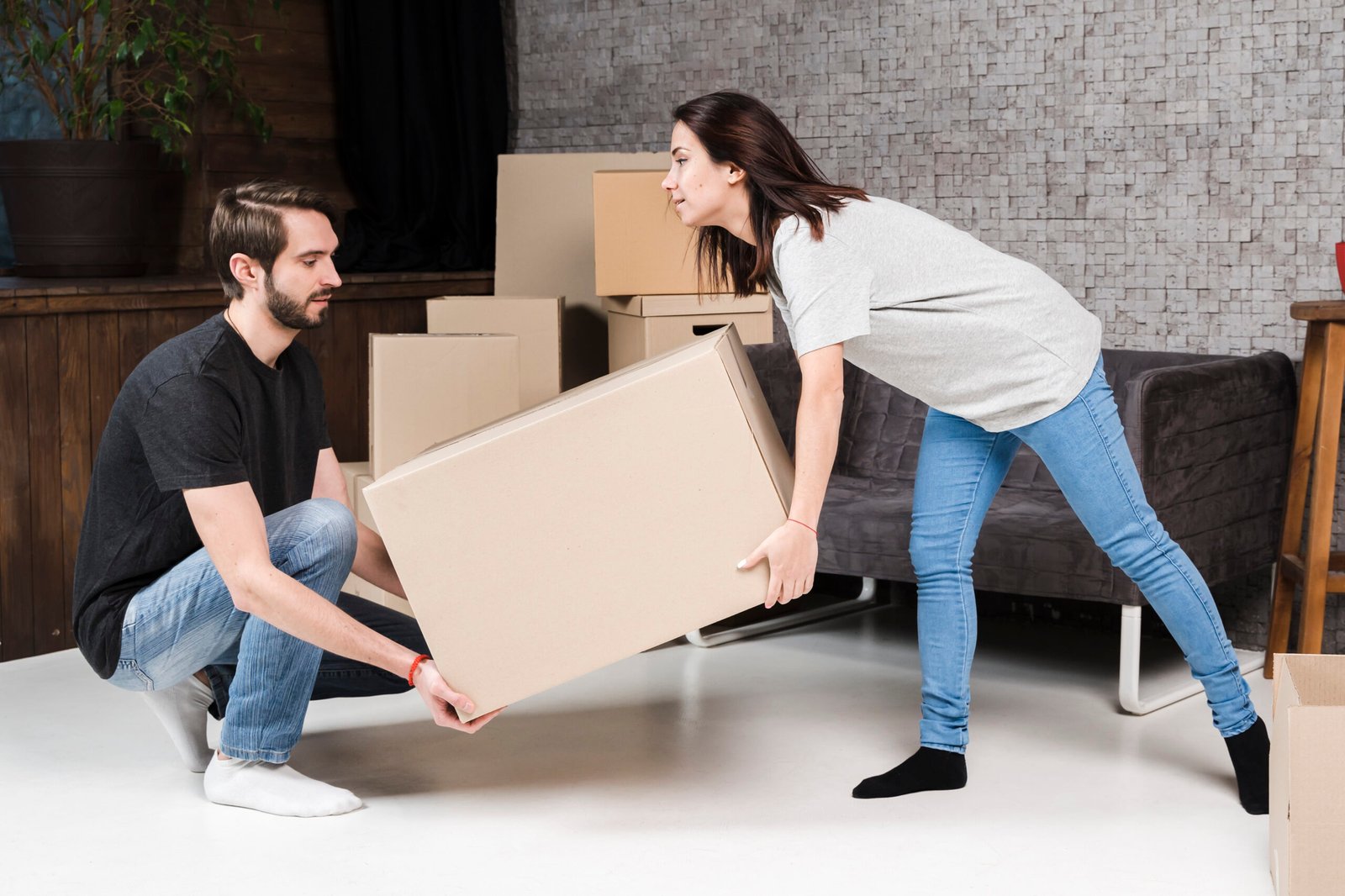adult-man-woman-carrying-cardboard-boxes