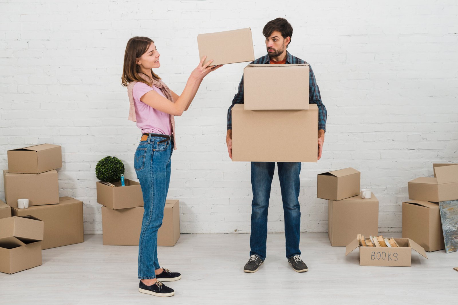 angry-man-looking-her-wife-stacking-cardboard-boxes-his-hands